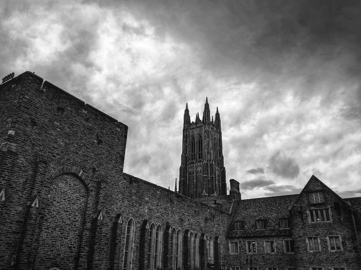 a dark cathedral building sits against the sky