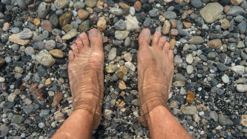 this is an image of someone standing on some rocks