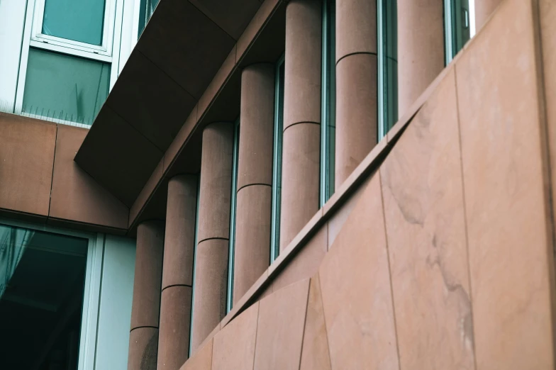 a tall brown building with a bunch of windows