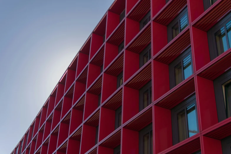 the building is made from red plastic panels