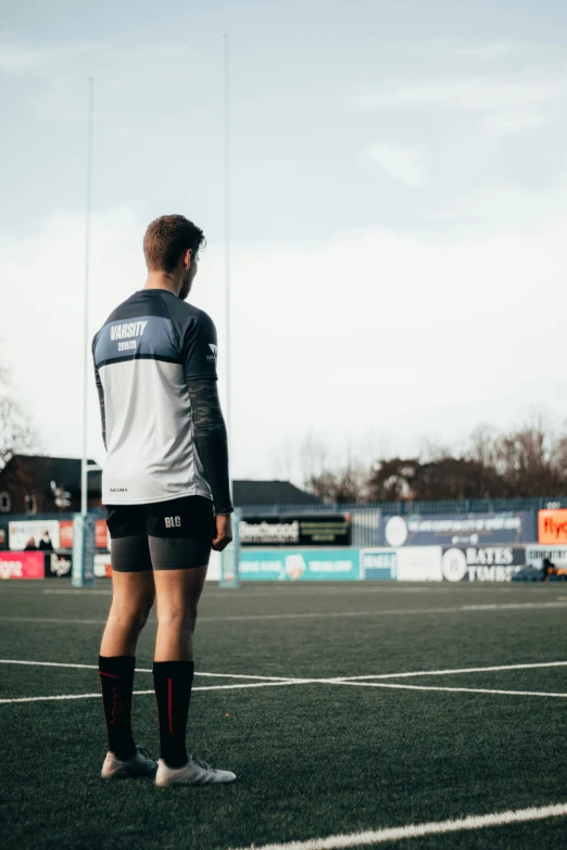 the back view of a young man in soccer shorts on the field