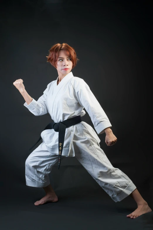 a woman in a white karate outfit