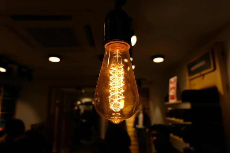 a light bulb hanging from a ceiling inside of a restaurant