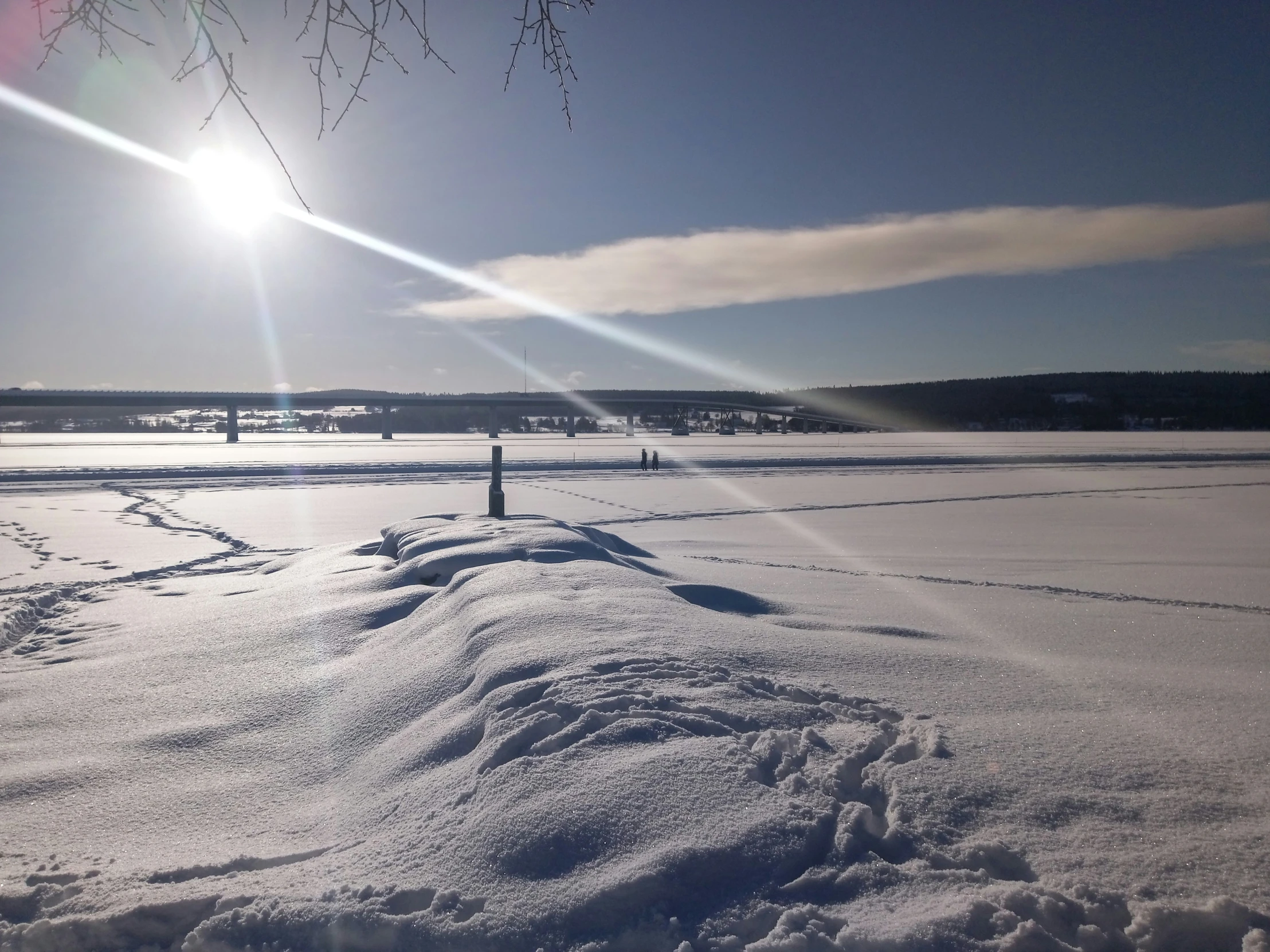 a snowy area with a sun light shining over it