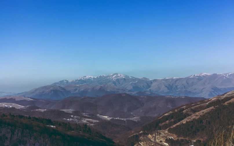 a beautiful view of a mountain range with snow covered peaks