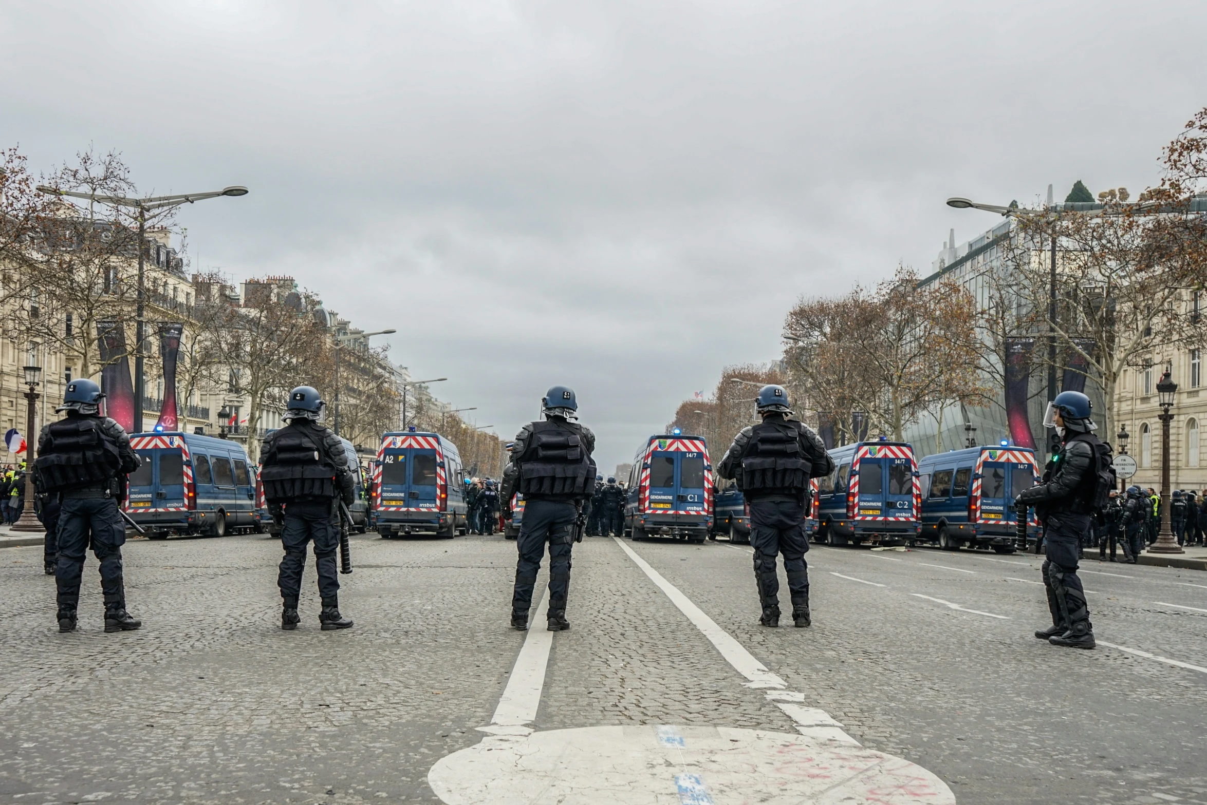 police stand in a parking lot on a cloudy day