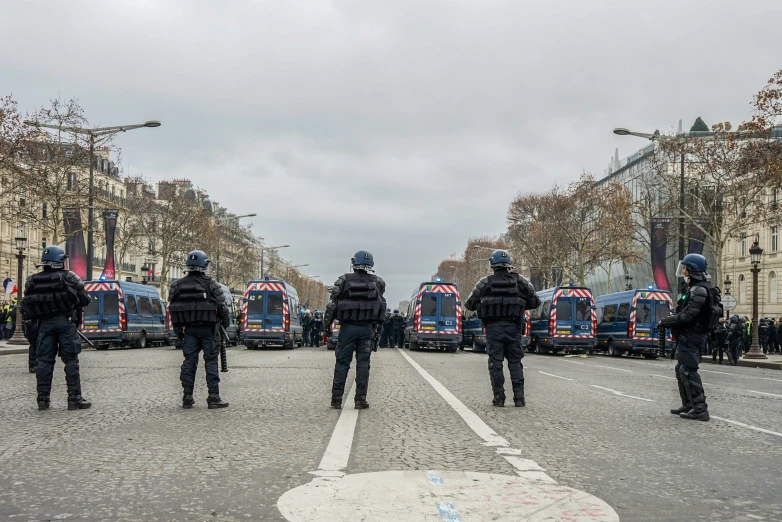 police stand in a parking lot on a cloudy day