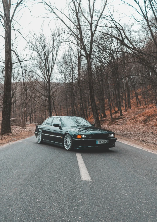 a black sports car is parked on the side of a road