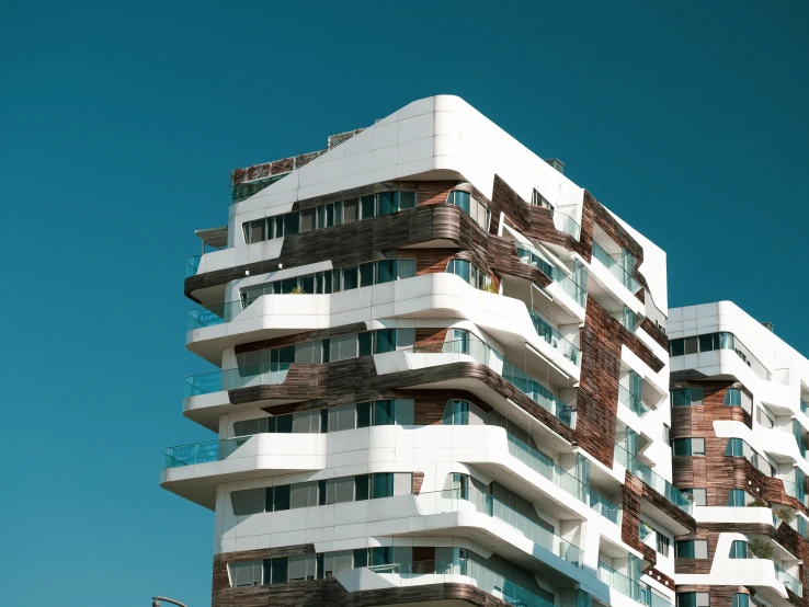 a large white building with balconies on top