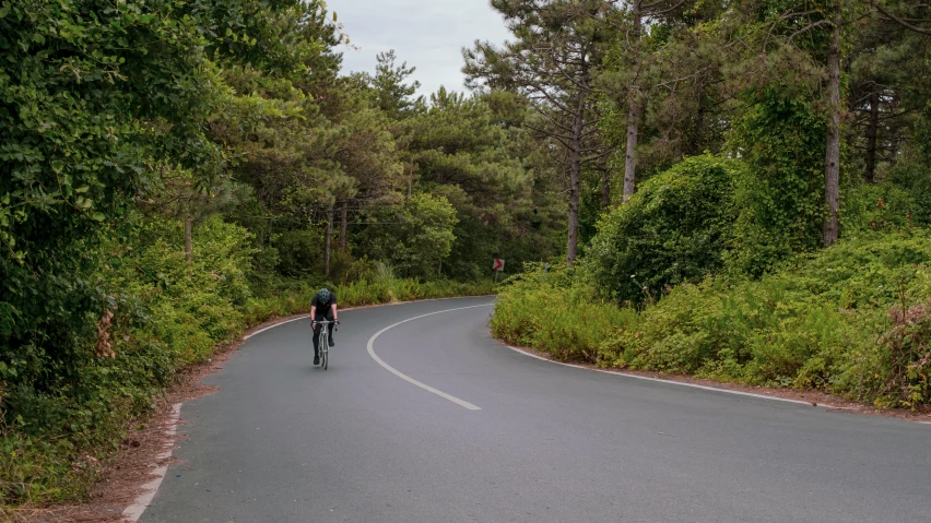 man on his bike in the middle of the road