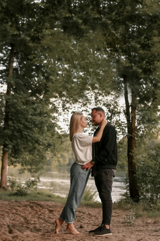 two people who are emcing each other near trees