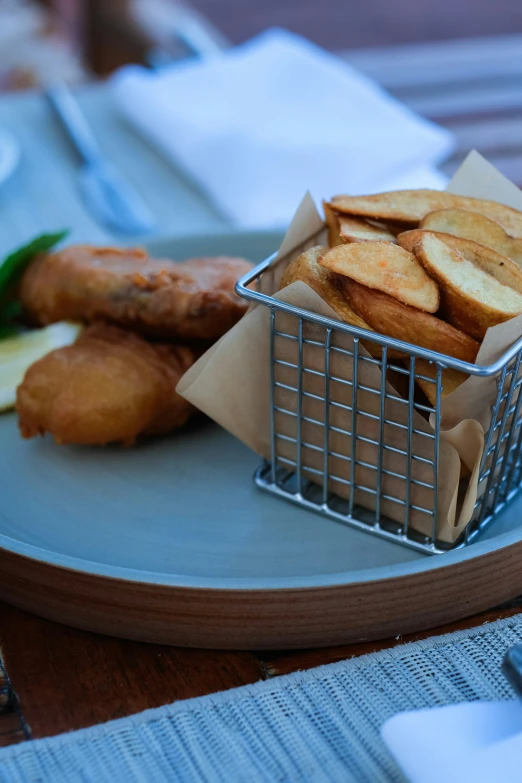 a basket full of bread sitting on top of a blue plate