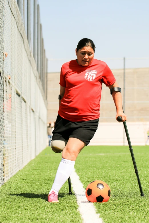 a soccer player is practicing with his ball