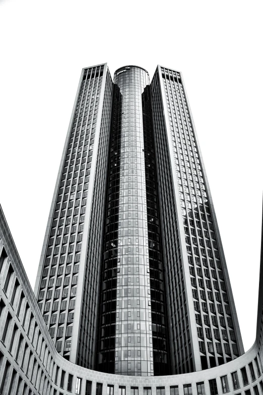 the tall tower with a massive clock is seen from ground level