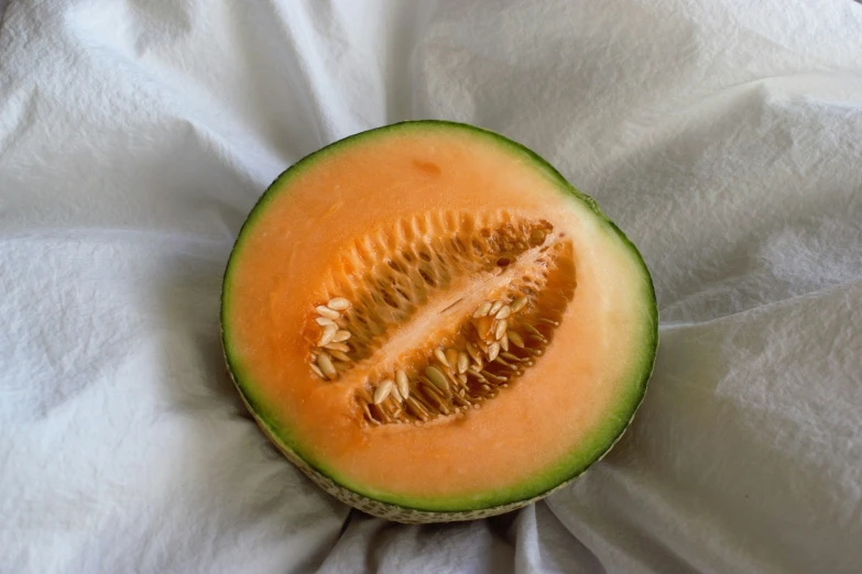 the inside of a half eaten watermelon on top of white paper