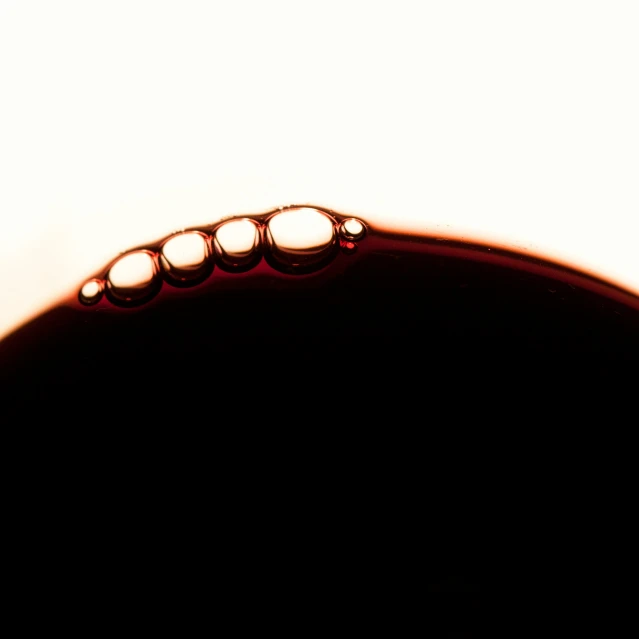 a water droplet of some sort on top of the liquid