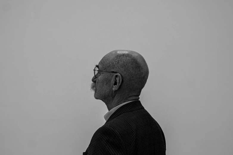 a man looking off into the distance with a white background