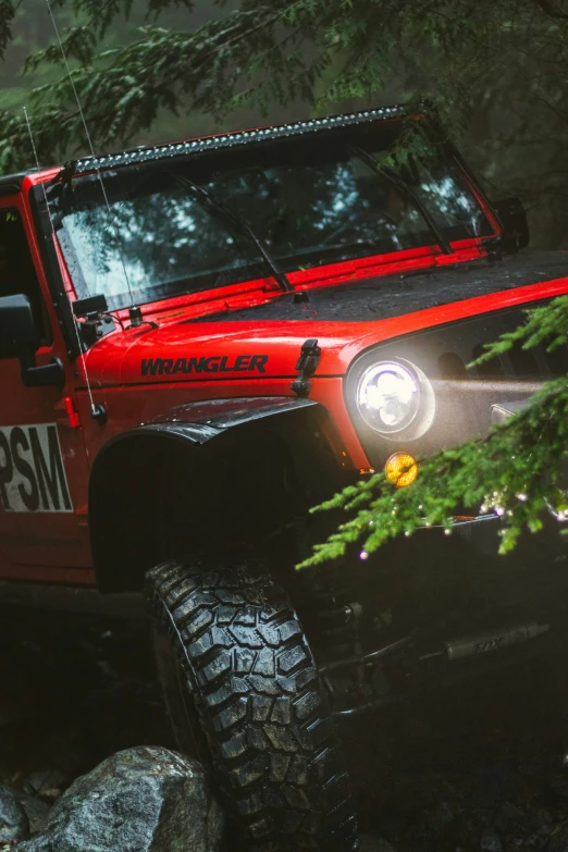 a jeep with a light on in the forest