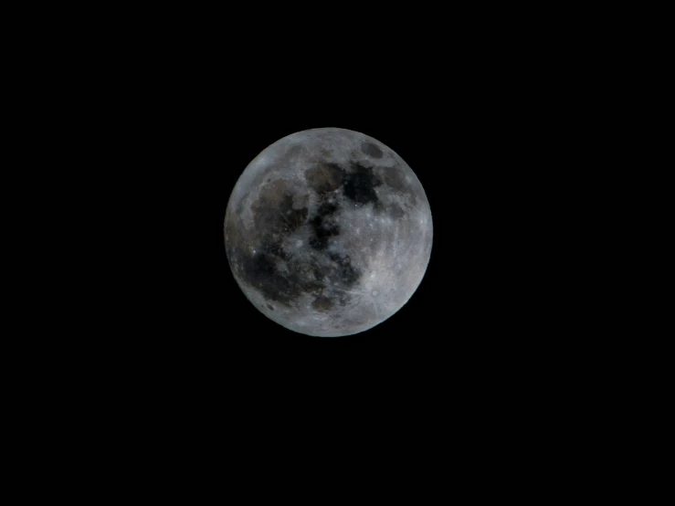 the moon seen over the sky with clouds