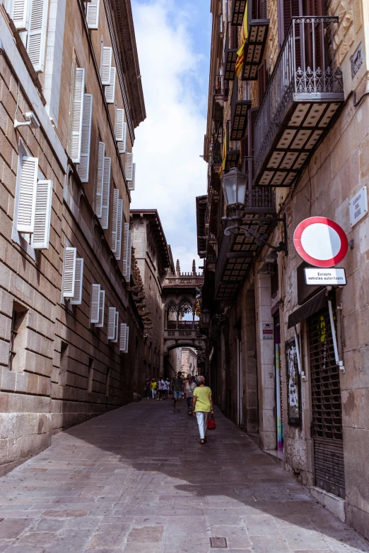 a person with a backpack is walking on a cobblestone street