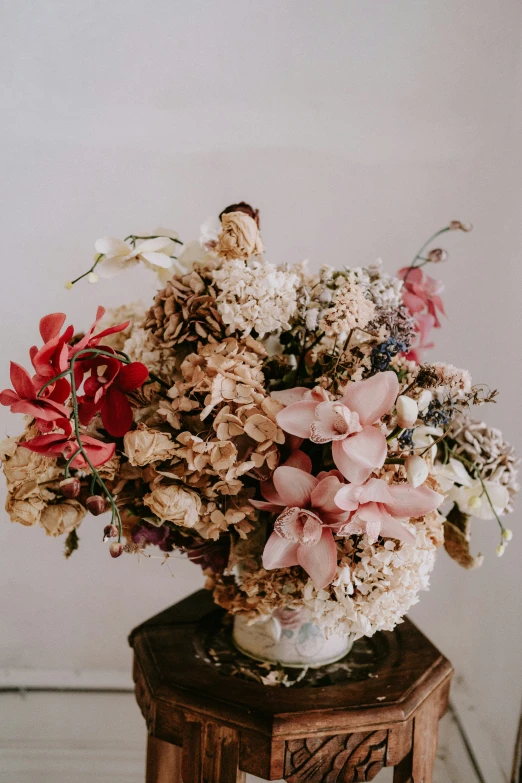 there are flowers on a small table on the floor