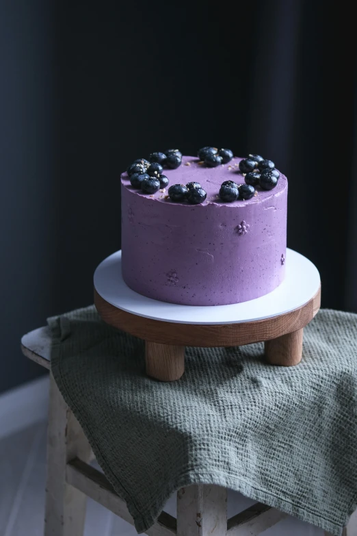 there is a purple cake with chocolate decorations on it