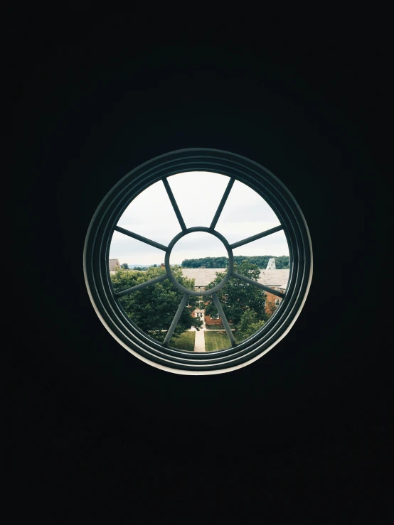 an upward view of the sky, through a round window