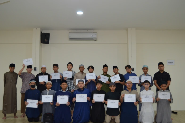 people hold up plaques while standing in an auditorium