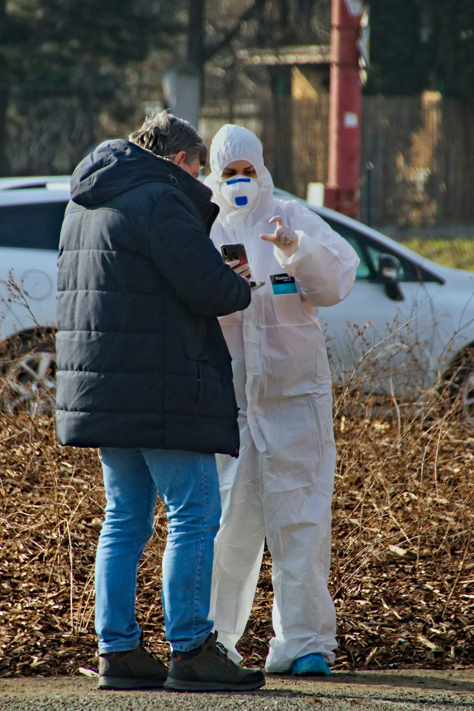 two people in costumes standing by some bushes