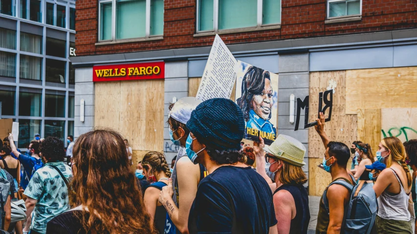 a group of people standing around holding up signs