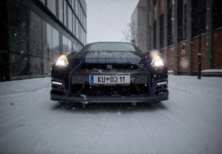 a bugatti car parked on the side of a road covered in snow