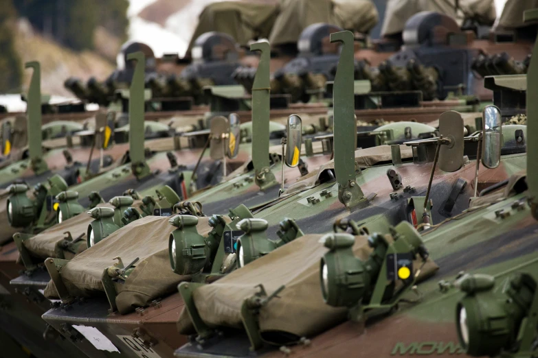 some army equipment that are sitting out in the grass