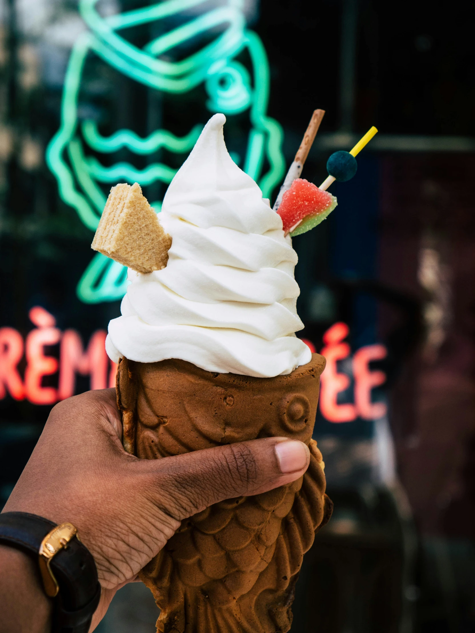 a person holding a brown ice cream sundae