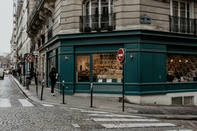 a man stands in front of a store window