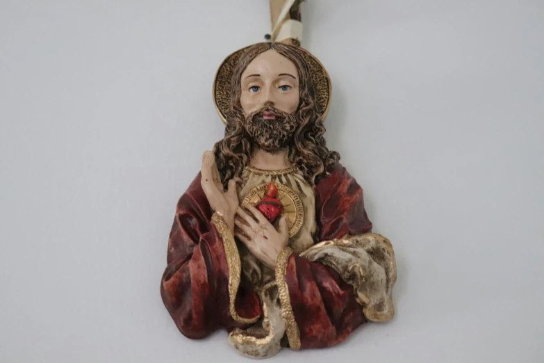 a wooden jesus statue hanging on the wall
