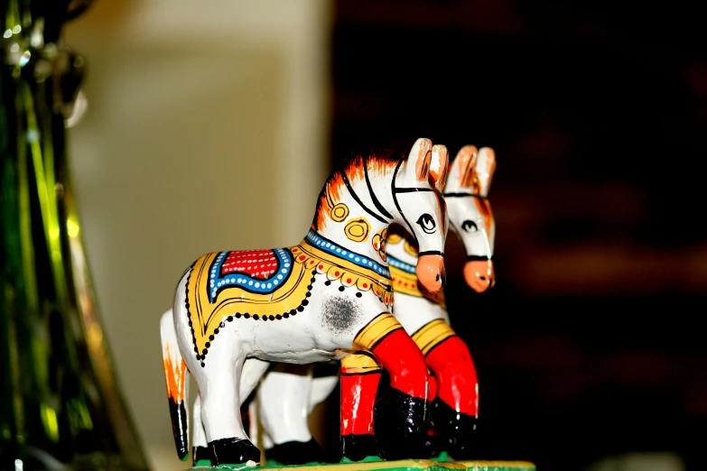 a small ceramic horse figurine sitting on top of a table