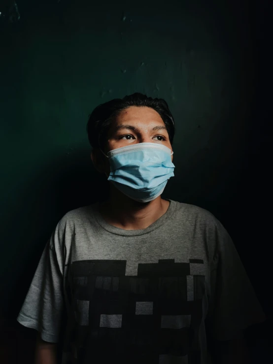 man wearing a face mask against dark background
