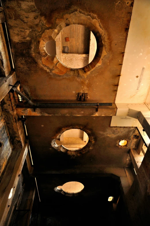 a restroom is shown in dark, dirty, crumbling concrete