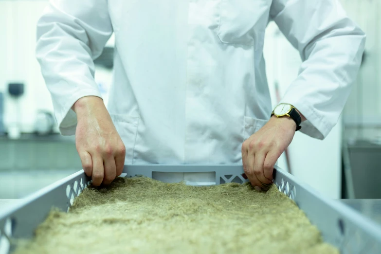 the factory worker has his hands on a grain silo