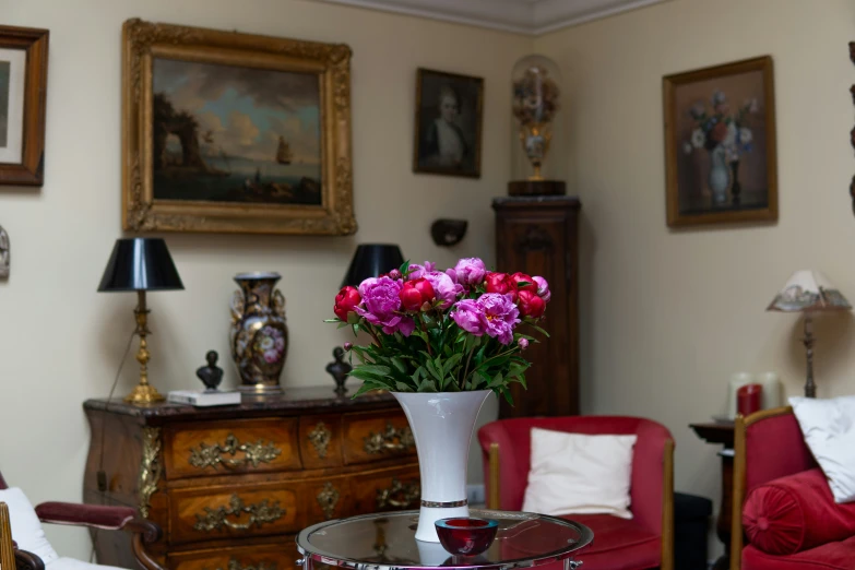 a vase with pink flowers in it sitting on a table