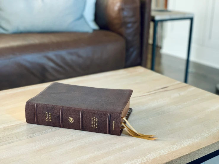 two small books sitting on top of a wooden table