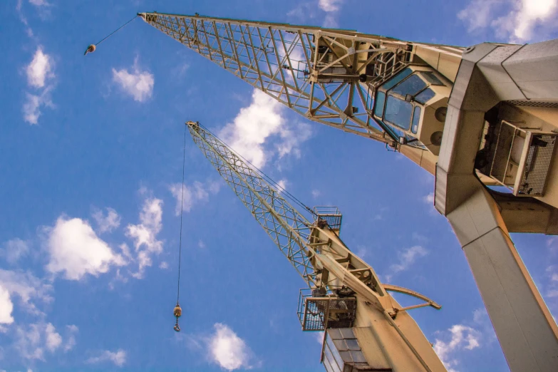 a pair of crane cranes are being lowered