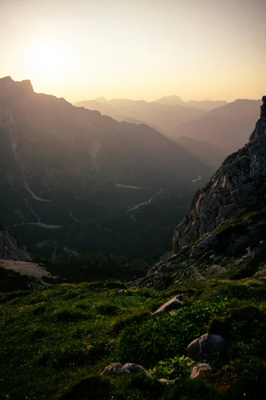 a view from the top of a mountain in the sun