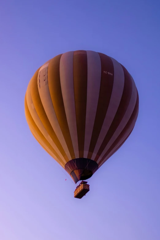 there is a large yellow balloon floating in the air