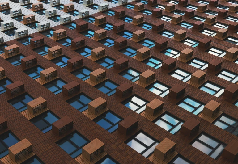 the facade of an abstract building, made of red bricks and windows