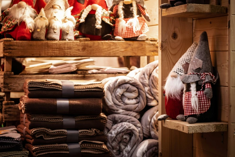 several blankets and gnome dolls in a store