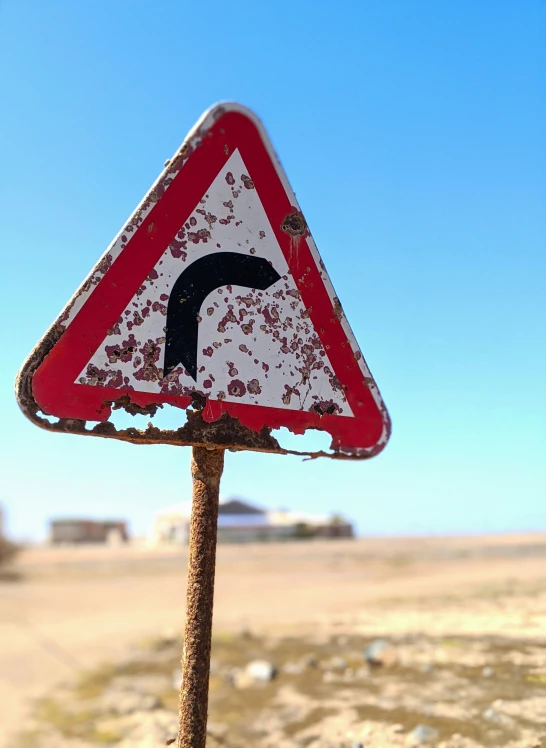 an upside down sign is displayed in the desert