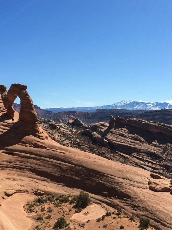 a beautiful scene with rocks, mountains and water