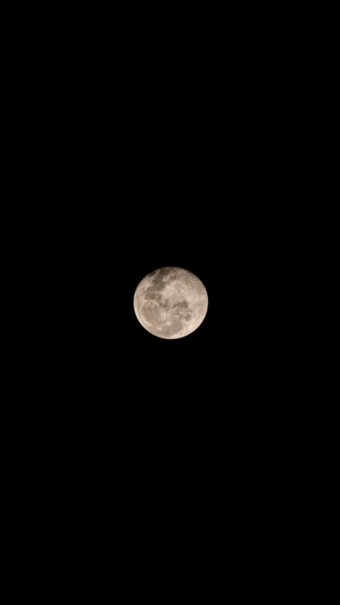 the moon is seen on a dark night sky
