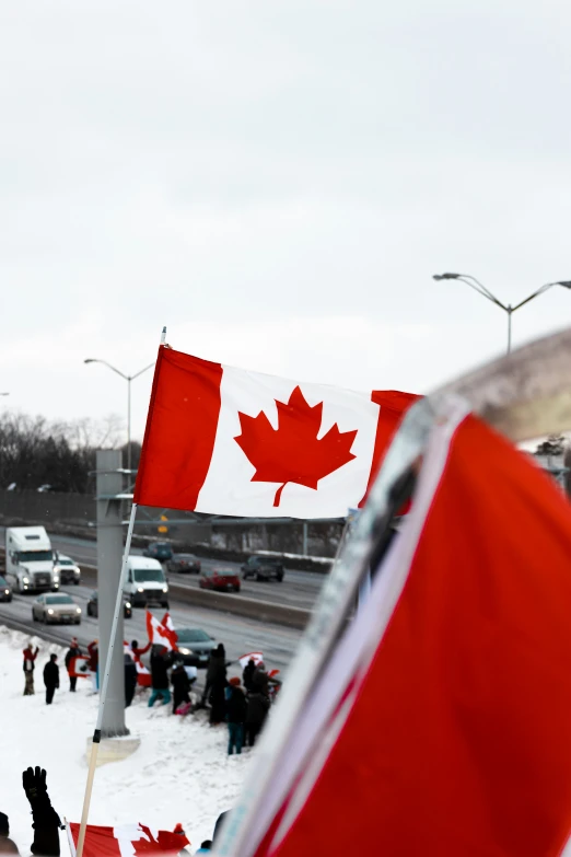 two flags with the canadian flag sticking out of them